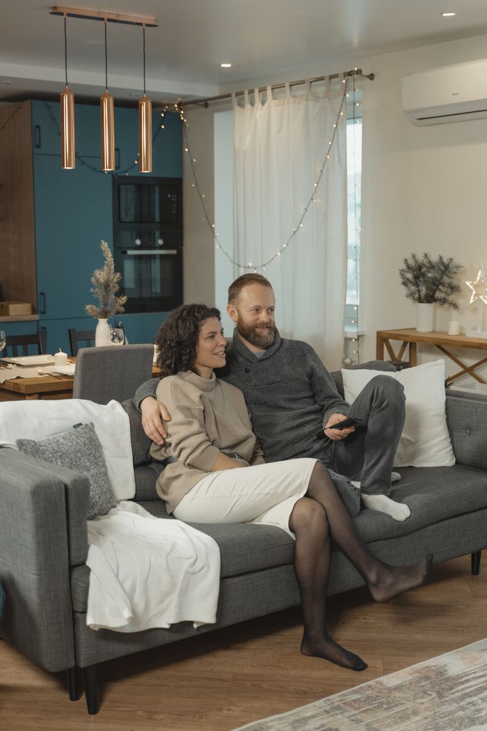 Crafting Captivating Headlines: Your awesome post title goes here A couple relaxes together on a modern sofa in a cozy living room, enjoying a peaceful moment indoors.